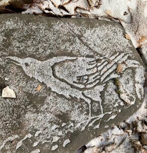 image of a crow etched in stone